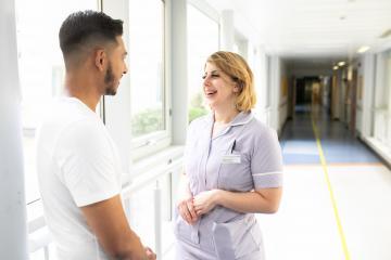 a man and woman talking in hospital