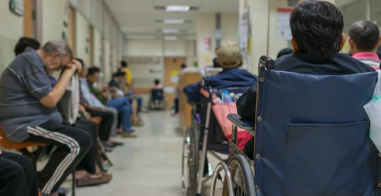 Hospital waiting room busy with patients 