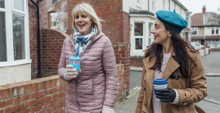 Two women walking down a street