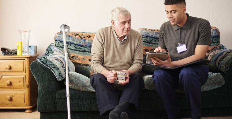 two men looking at ipad