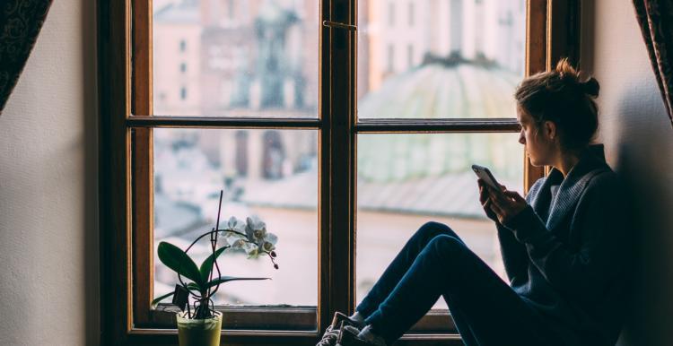 woman looking outside of the window