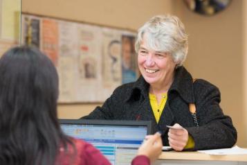 Woman smiling at GP