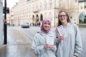 Two young female volunteers promoting Healthwatch