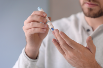 Man doing the diabetes finger prick test