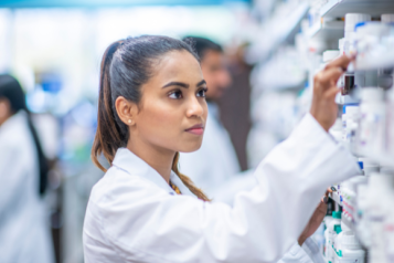 woman choosing medication in pharmacy