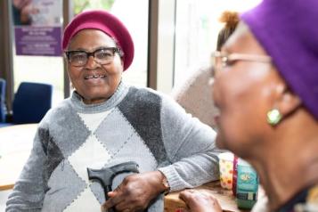 Two ladies sat in a community space talking