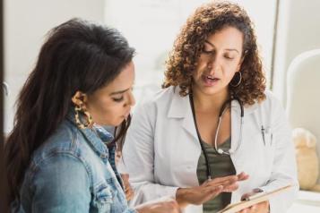 Female doctor providing information to female patient