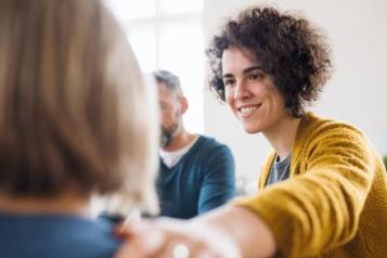 Woman supporting another woman in a group setting