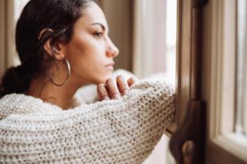 woman looking outside window