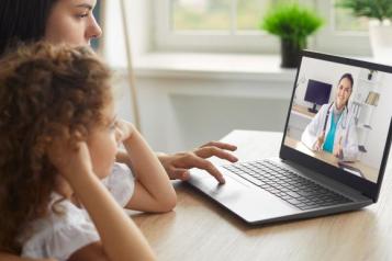 lady and little girl looking at a laptop