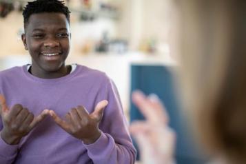 teenage boy and girl talking in sign language.jpg